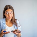 Confused woman with contact lenses and glasses