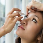 Woman using eye drops