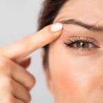 eyelid twitch woman pointing to her eye