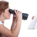 Woman reading a book using binoculars