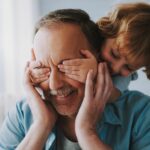 Older man playing with grandchild