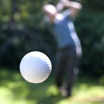 A golf ball coming off the tee