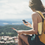 Woman checking her phone outside